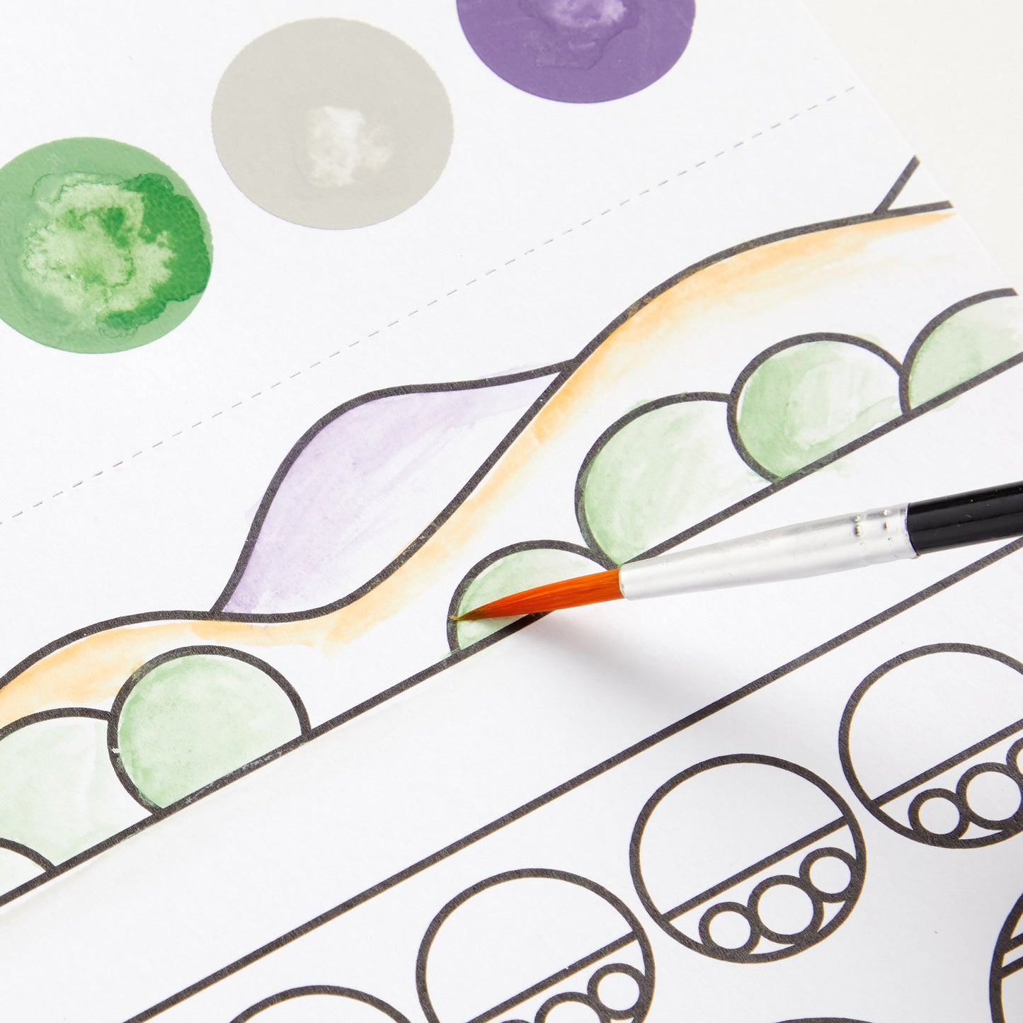 Coloring book page with green and purple circles and a paintbrush.
