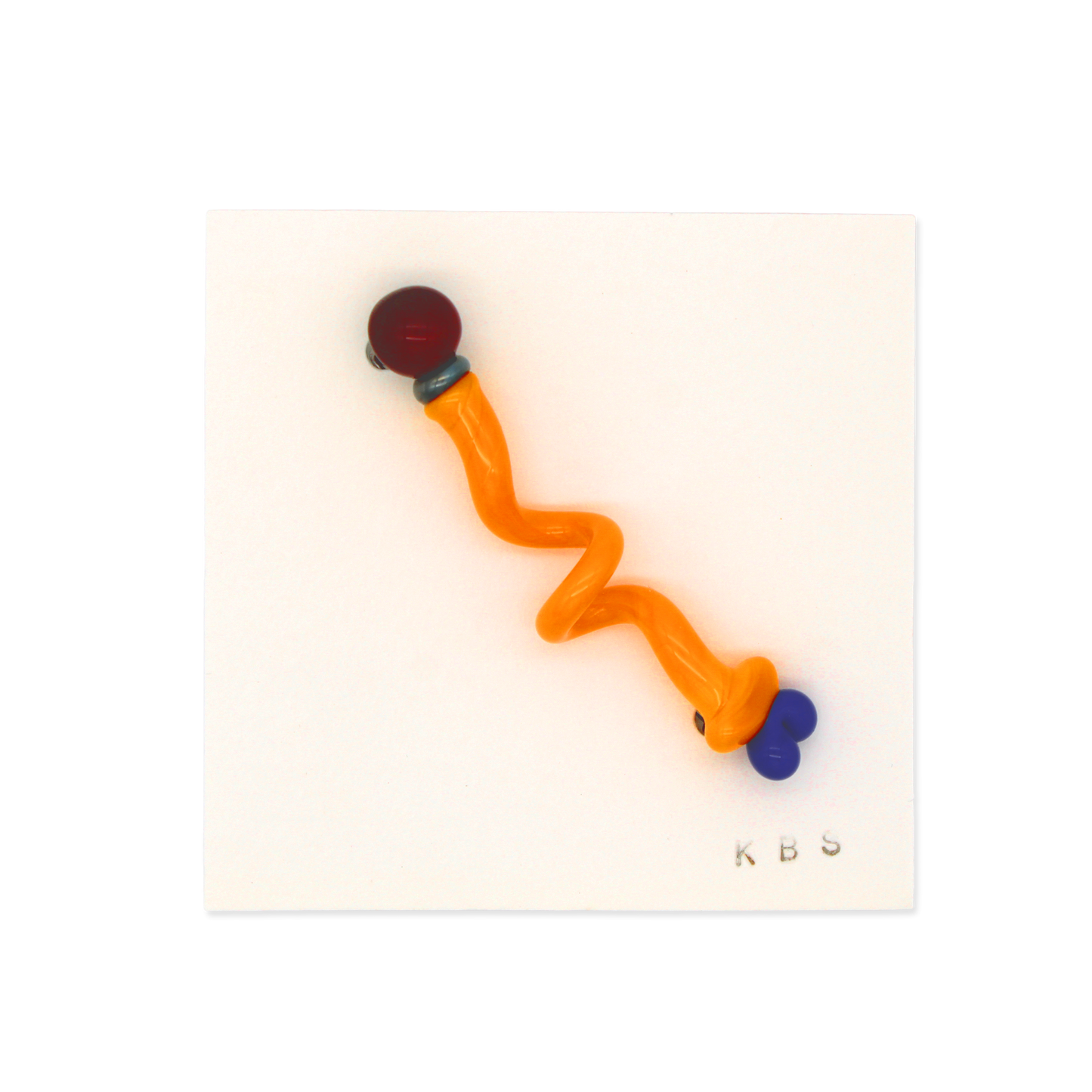 Glass pin/brooch by Krista Bermeo in red, yellow, and blue.