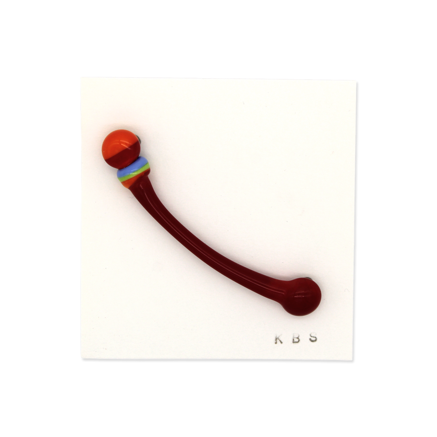Glass pin/brooch by Krista Bermeo in dark red, with orange accent.