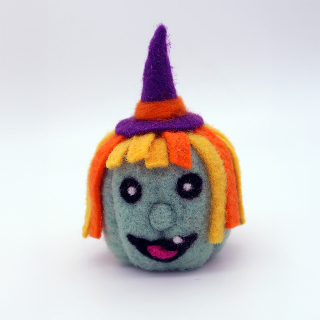 Toy figure with a witch hat and colorful hair on a white background