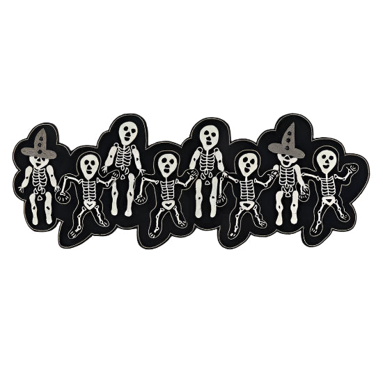 Row of skeleton figures with witch hats on a white background