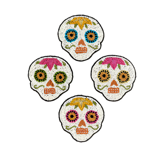 Four colorful beaded sugar skull coasters on a white background