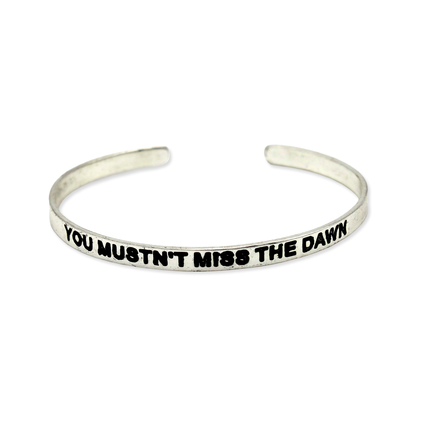 Silver cuff with the motto "You mustn't miss the dawn."