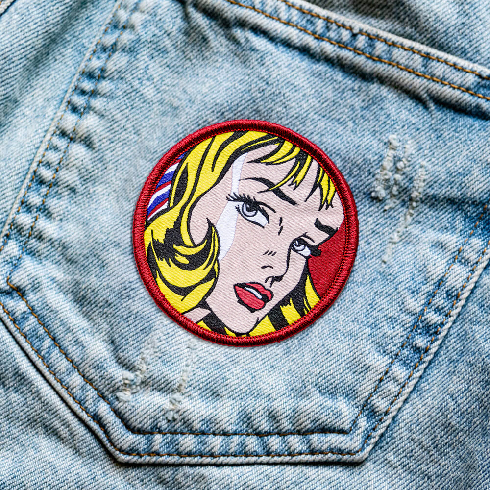Comic-style patch of a woman's face on a denim jacket