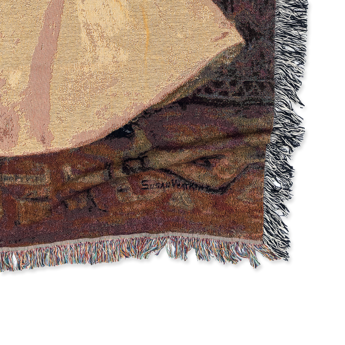 Close-up of a textured fabric with geometric patterns and fringes on a white background