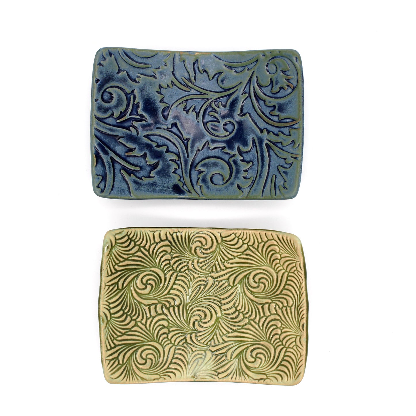 Two rectangular ceramic dishes with decorative patterns on a white background