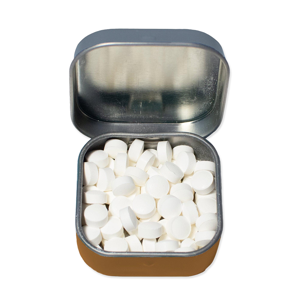Small open tin filled with white mints on a white background
