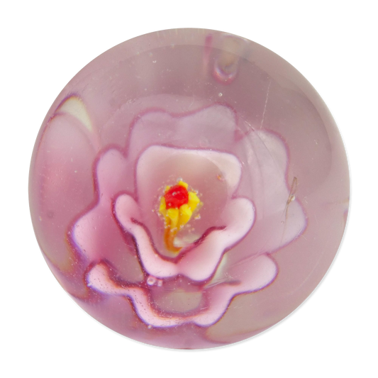Pink glass marble with a yellow center on a white background