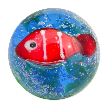 Glass fish marble with a red fish inside a clear sphere on a white background