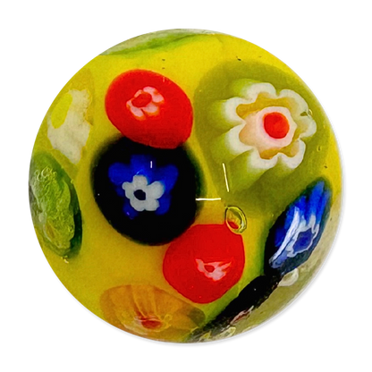 Colorful glass marble with floral patterns on a white background