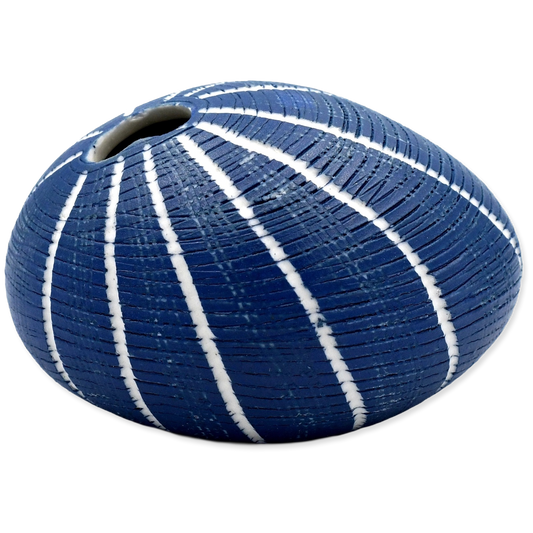 Blue ceramic vase with white stripes on a white background