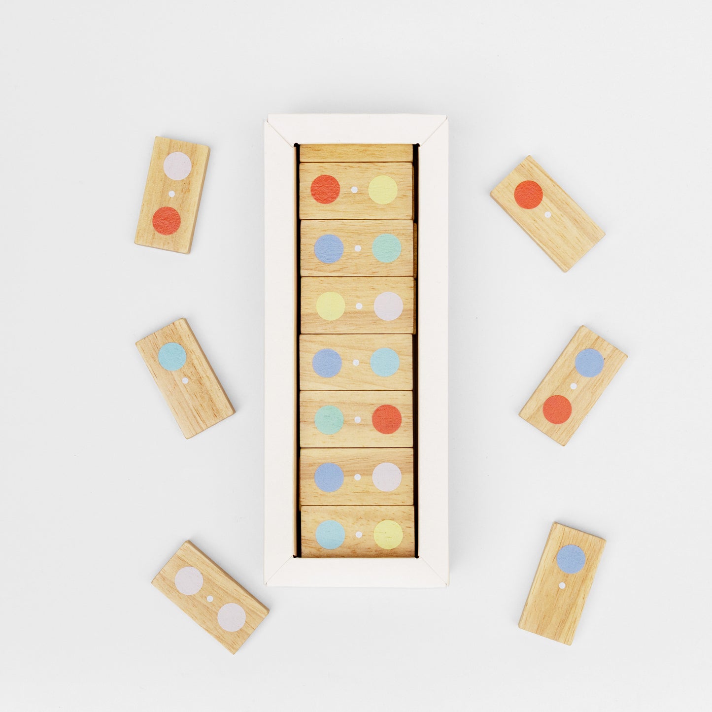Wooden block puzzle with colorful dots on a white background