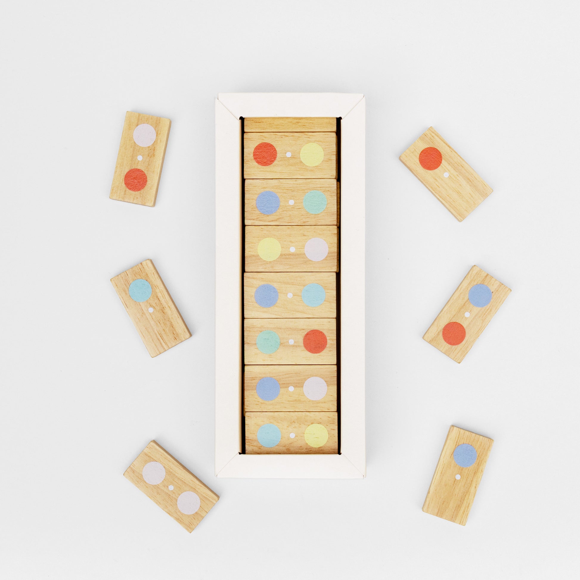 Wooden block puzzle with colorful dots on a white background