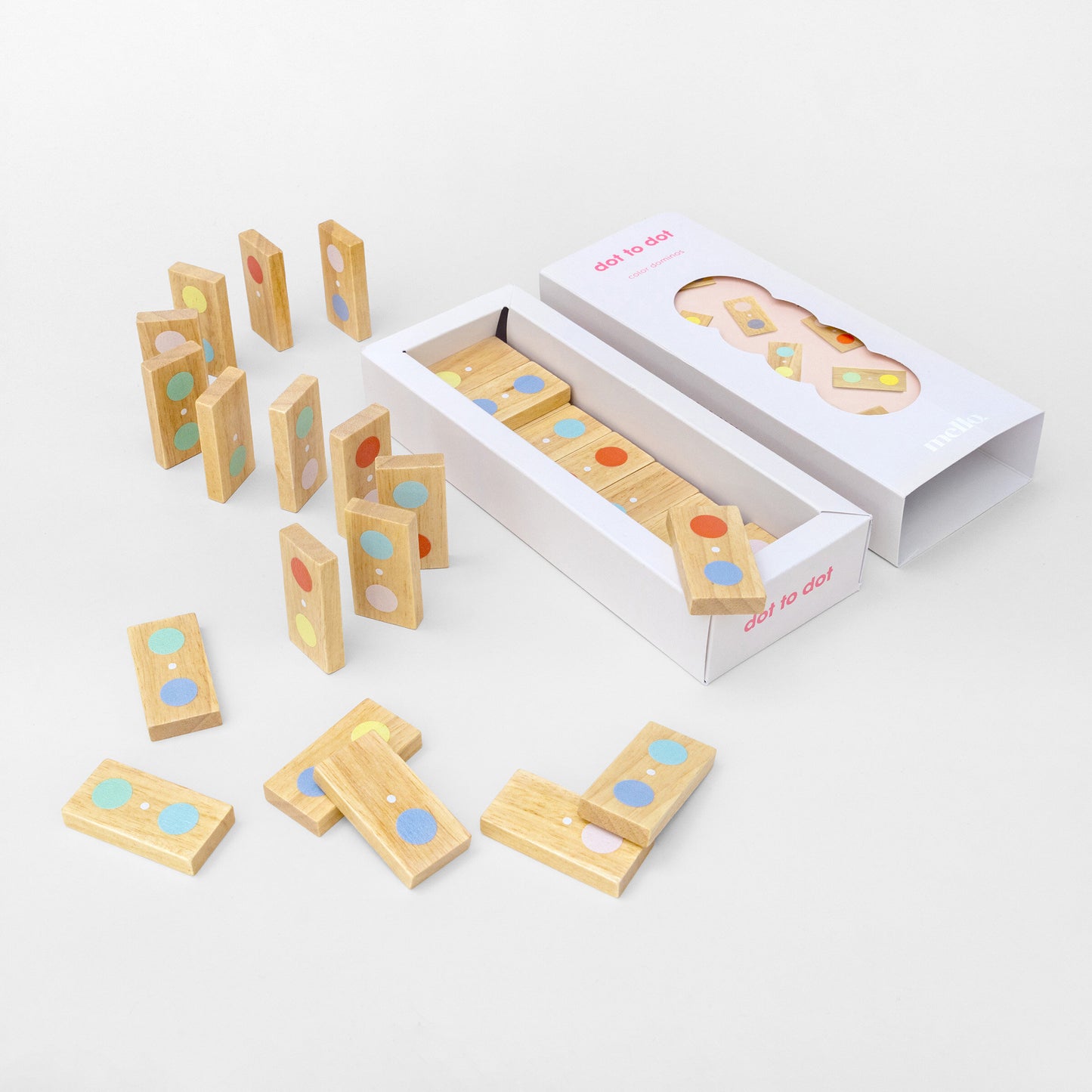 Wooden dot tiles with colorful circles and their packaging on a white background