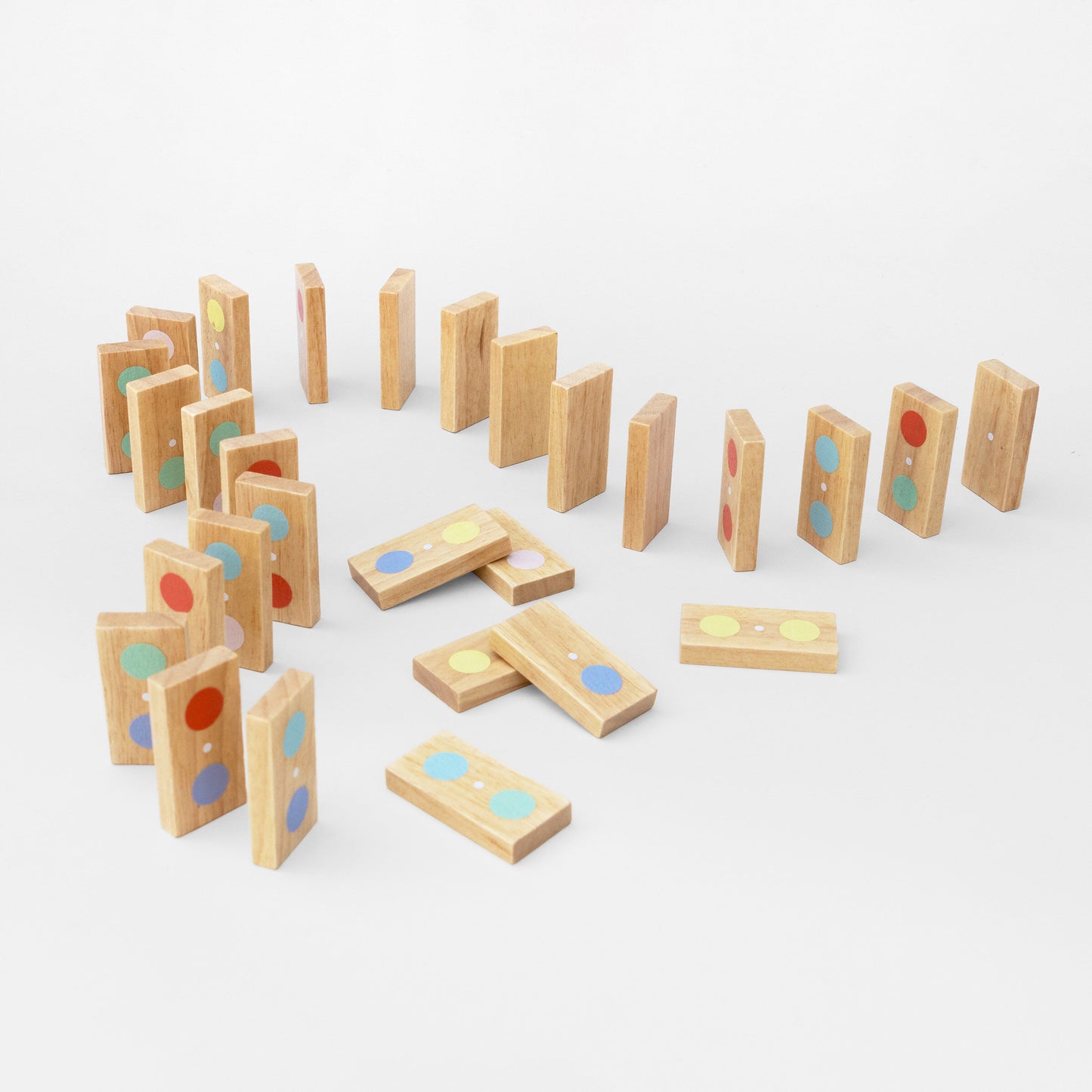 Set of wooden dominoes with colorful dots on a white background
