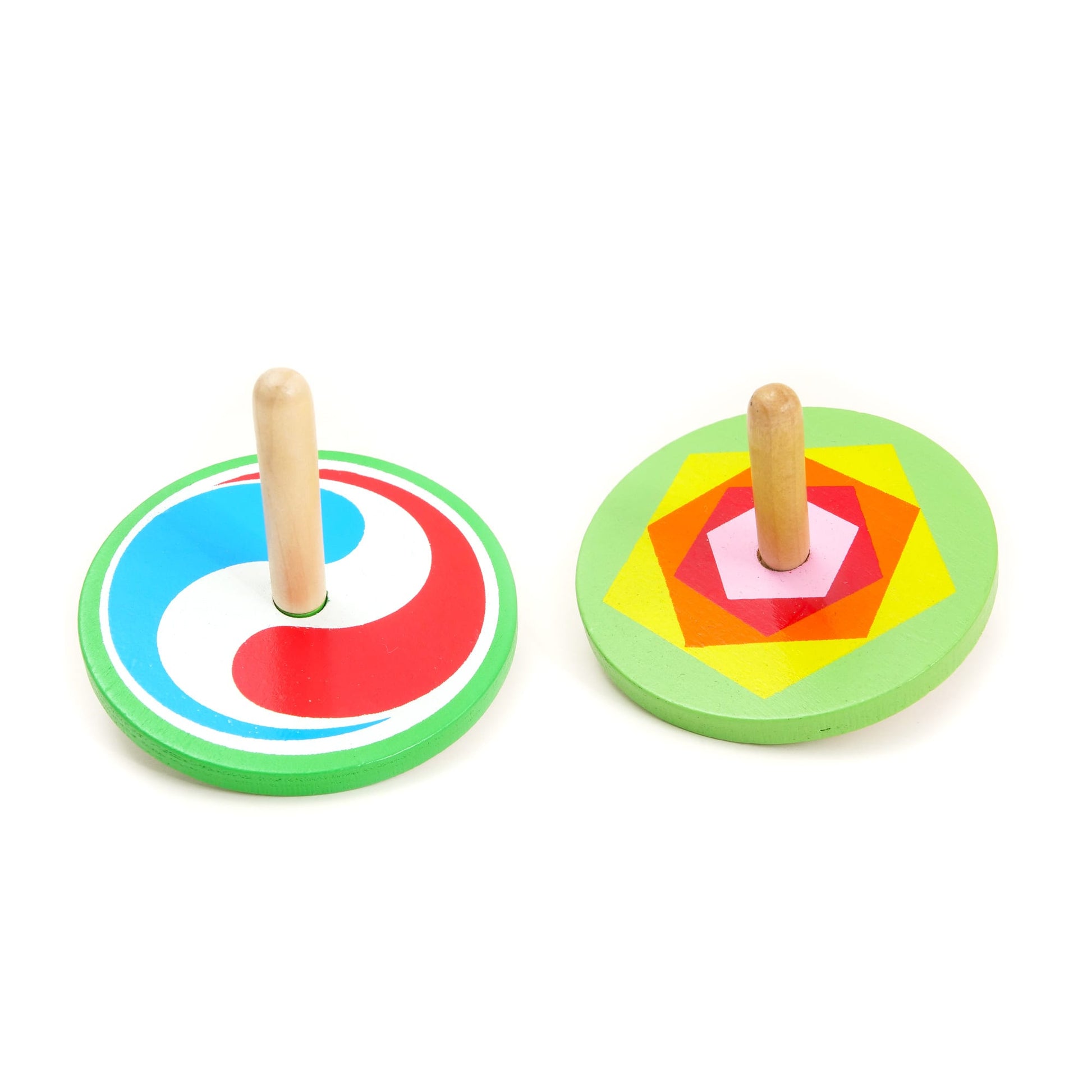Two colorful wooden spinning tops on a white background