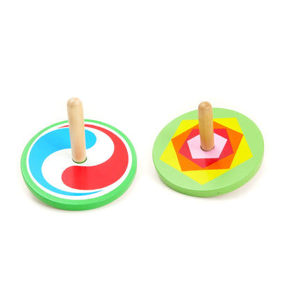 Two colorful wooden spinning tops on a white background