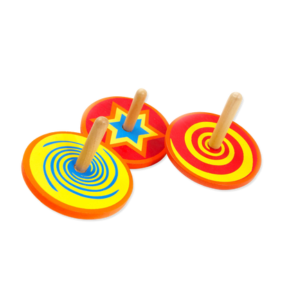 Colorful wooden spinning tops on a white background