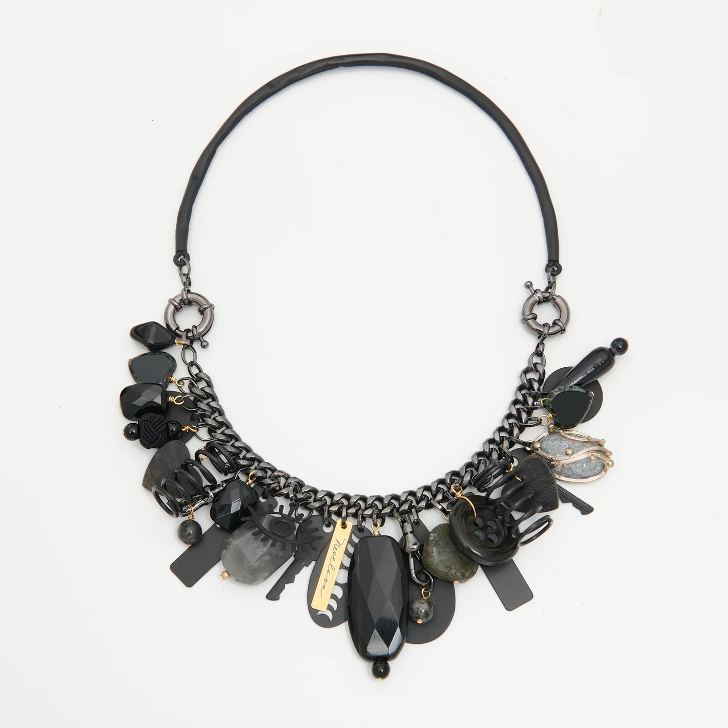 Black and gold necklace with various beads on a white background