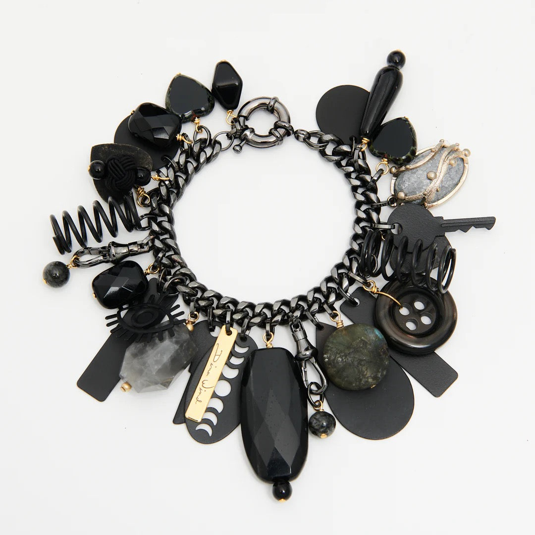 Black and gold charm bracelet on a white background