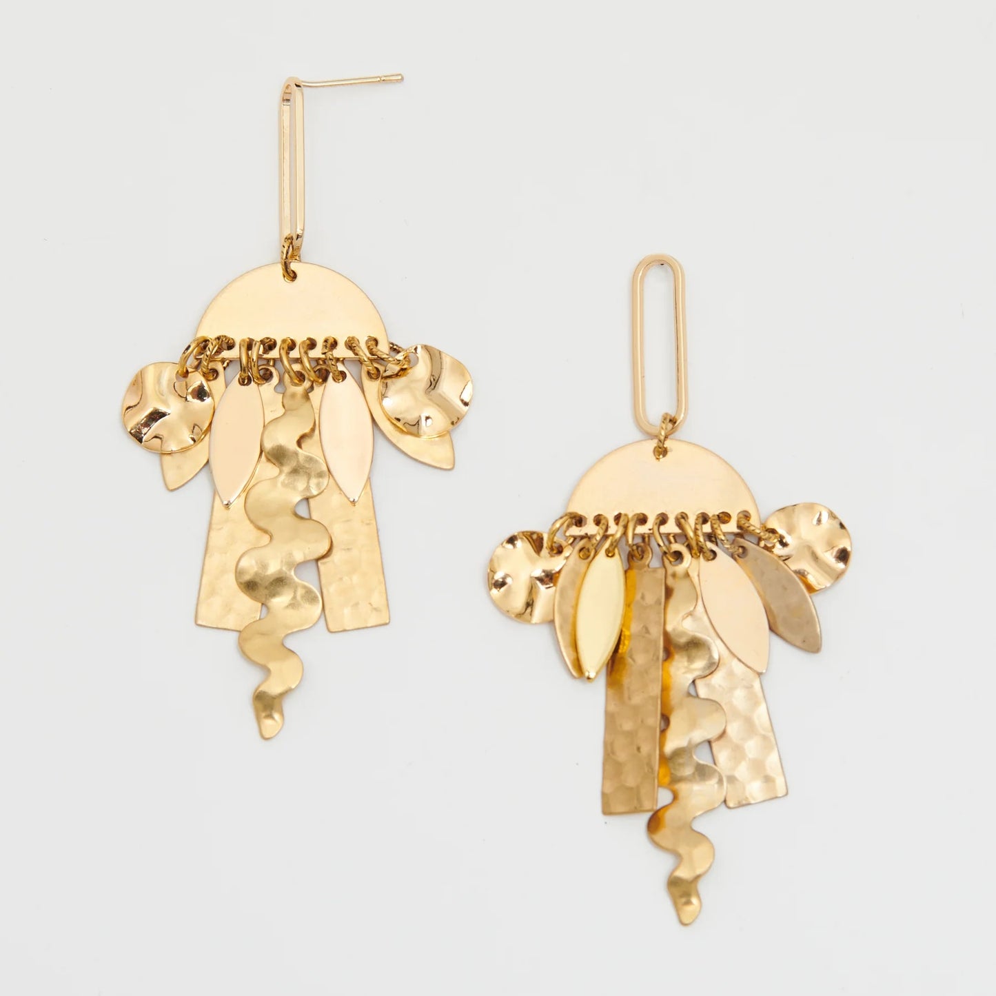 Pair of golden 'Dawn' earrings with abstract shapes hanging from semi-circles.