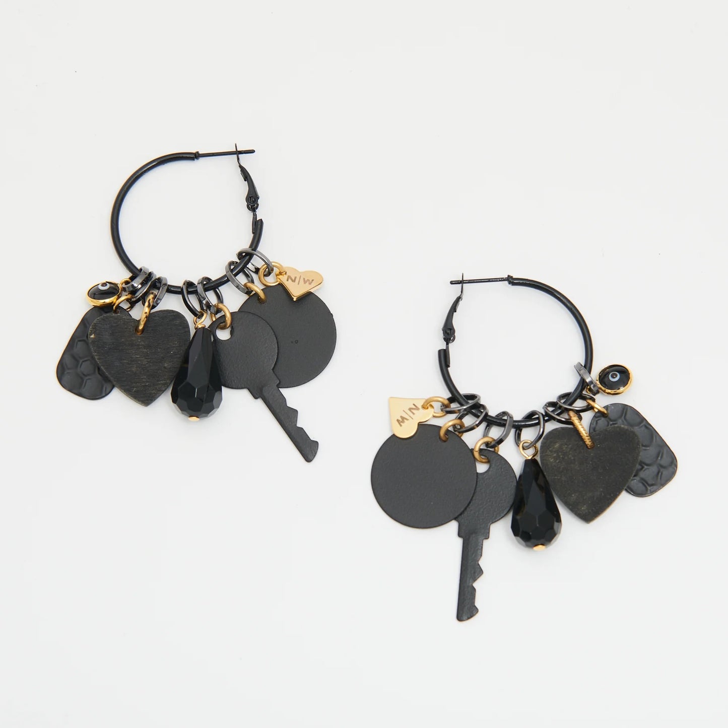 Black hoop earrings with key and heart charms on a white background