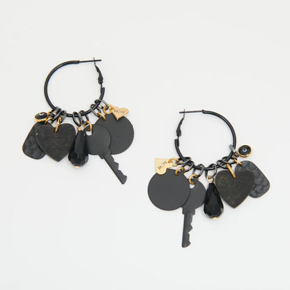 Black hoop earrings with key and heart charms on a white background