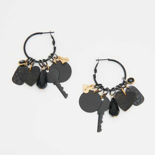Black hoop earrings with key and heart charms on a white background