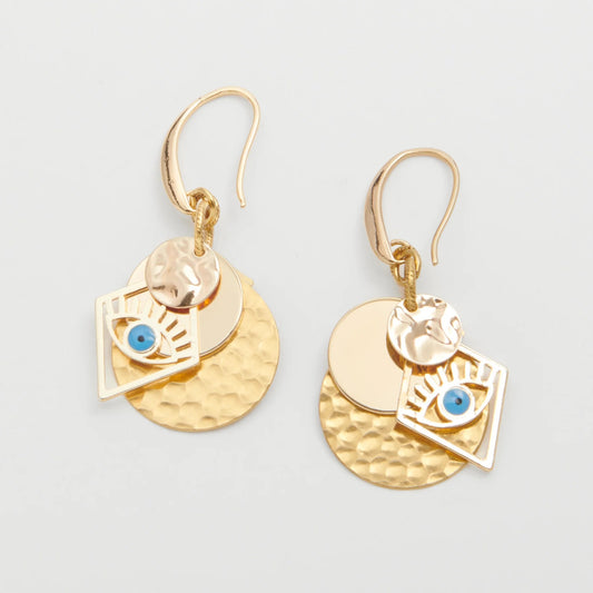 Gold earrings with circular designs and blue stones on a light gray background