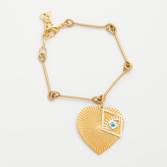 Gold bracelet with a heart-shaped pendant featuring an eye design on a white background