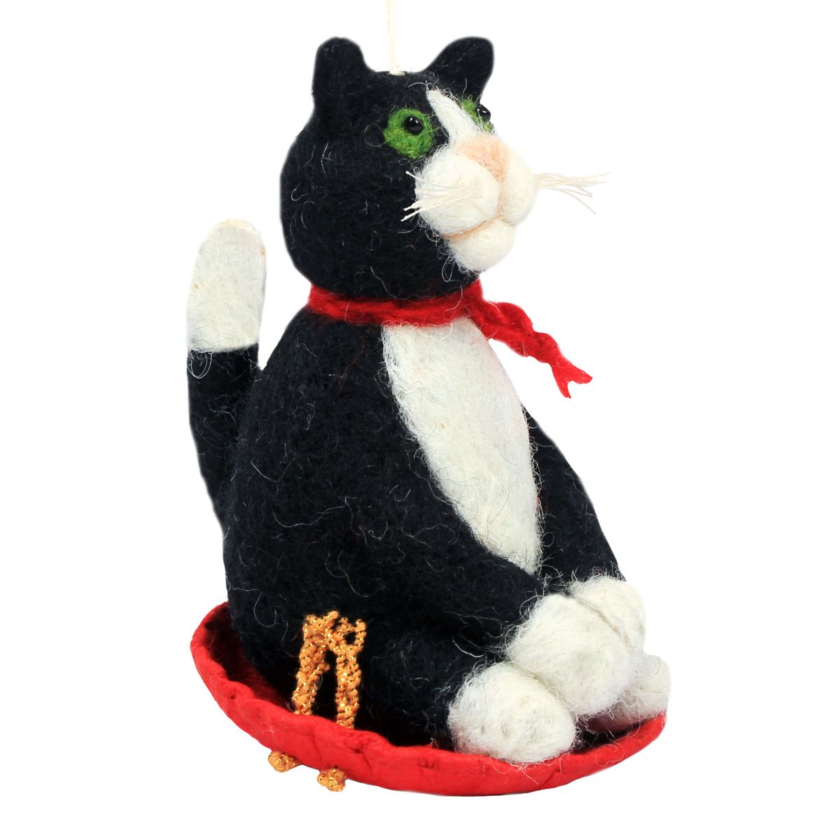Black and white cat-shaped ornament with a red scarf on a white background