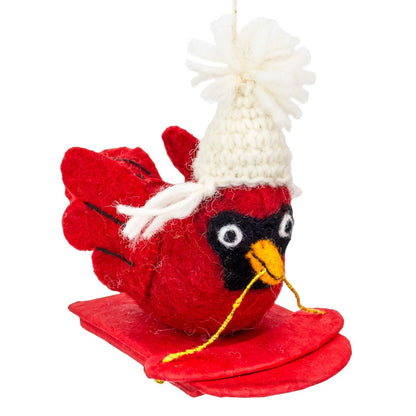Red bird ornament with a white knitted hat on a white background