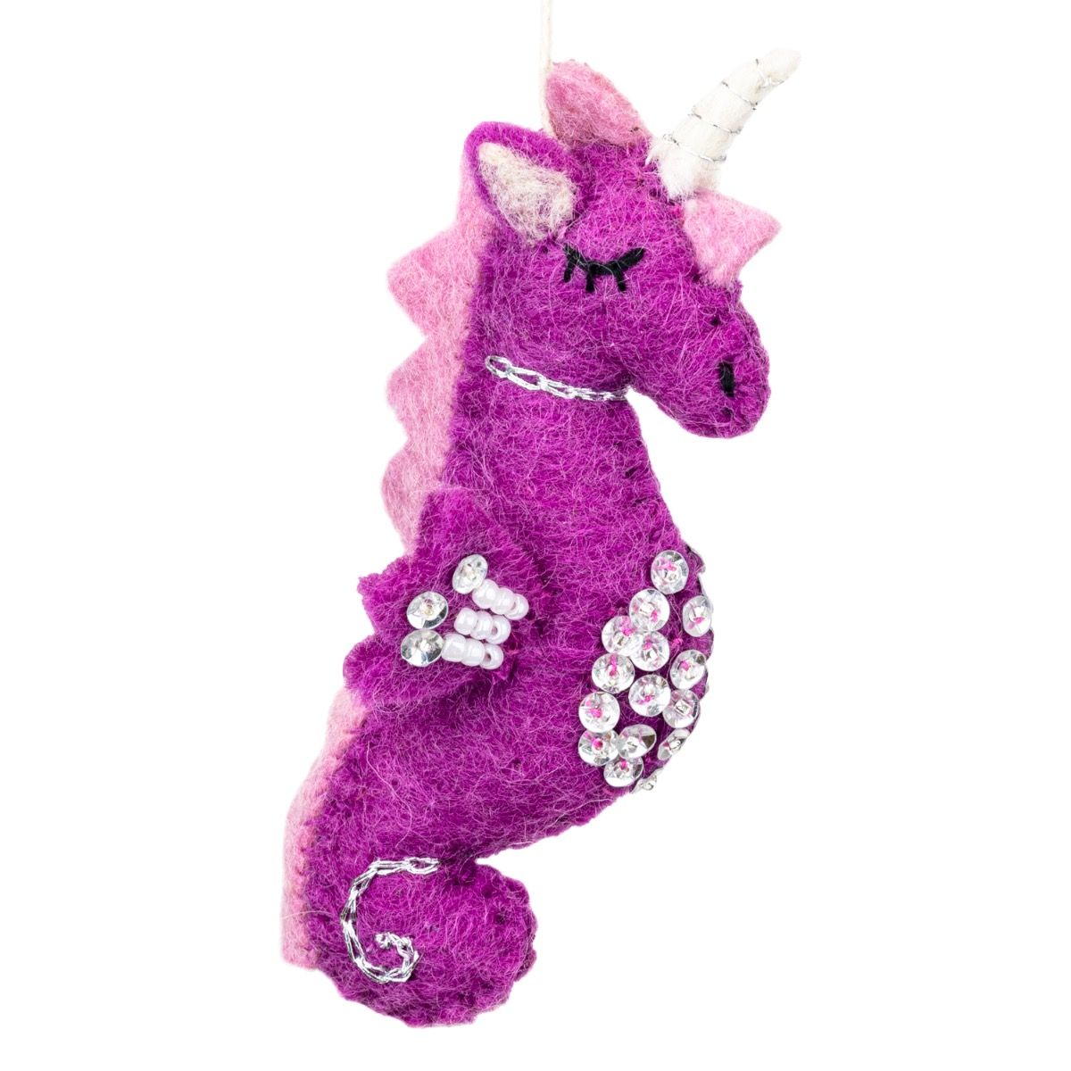 Purple and pink unicorn seahorse wool ornament with rhinestones on a white background