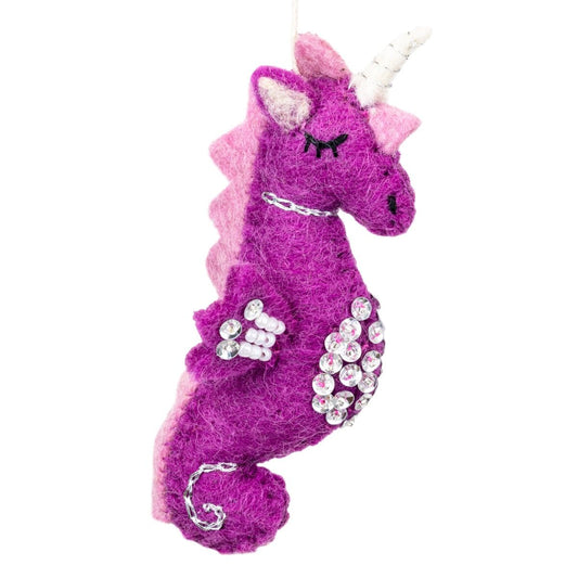 Purple and pink unicorn seahorse wool ornament with rhinestones on a white background