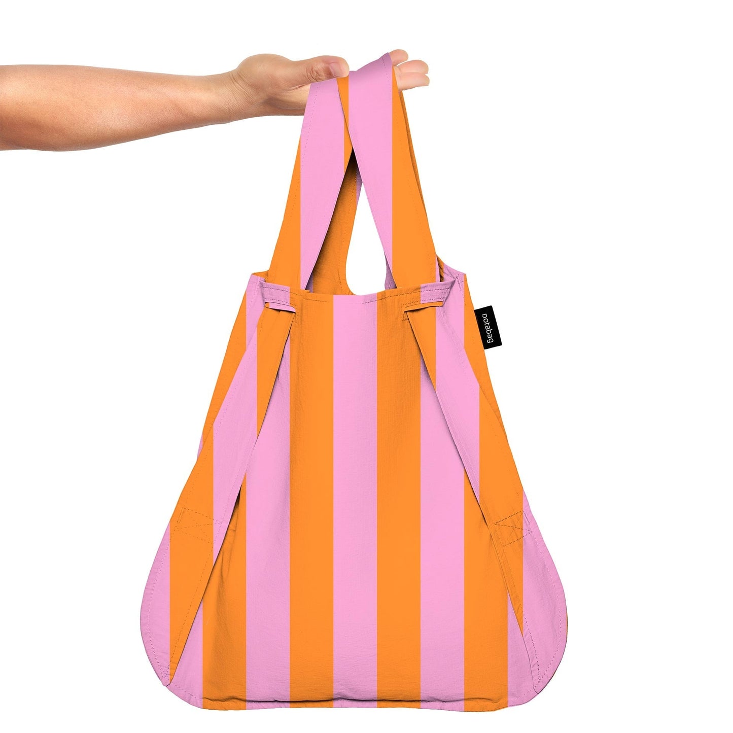 Pink and orange striped bag held by a person on a white background