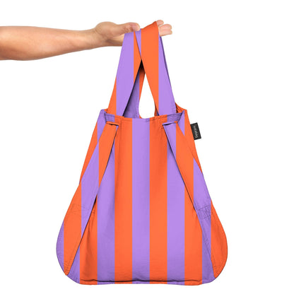 Orange and purple striped tote bag held by a person on a white background