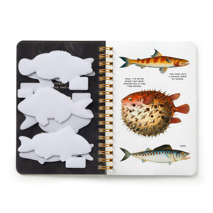 Notebook with fish illustrations and stickers on a white background