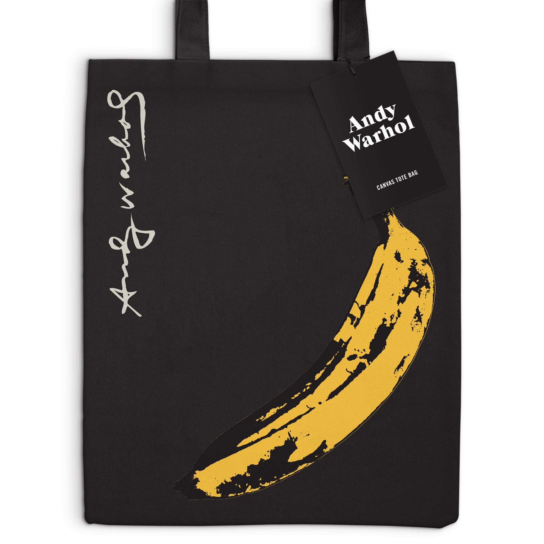 Black tote bag with yellow banana graphic and Andy Warhol signature, featuring a tag with 'Andy Warhol' branding.