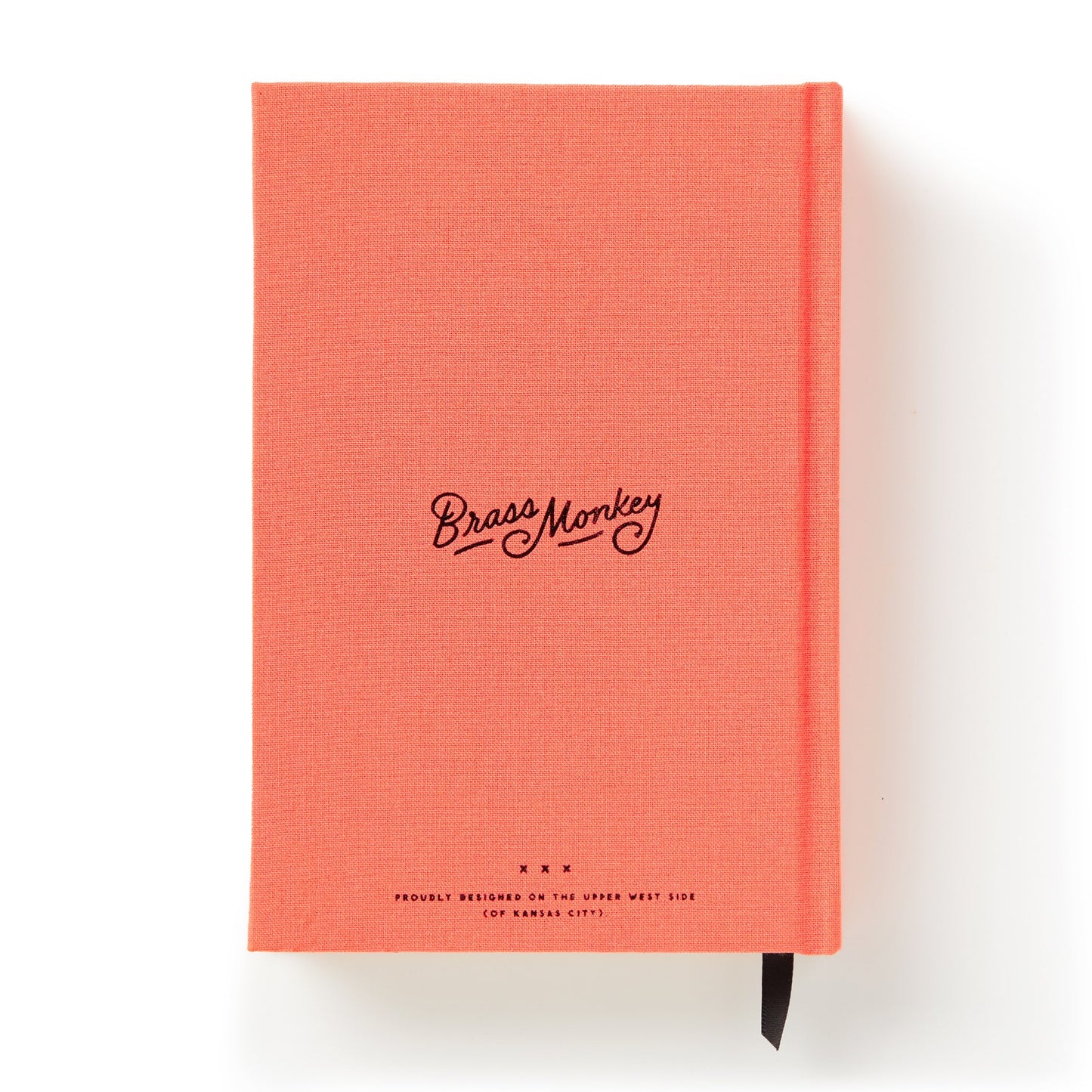 Coral notebook with 'Brass Monkey' branding on a white background