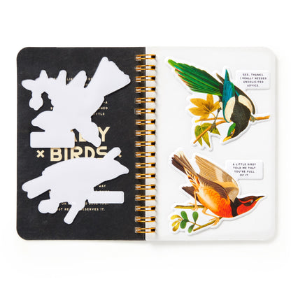 Notebook with bird-themed stickers on a white background