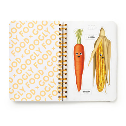 Notebook with a carrot and corn illustration on a white background