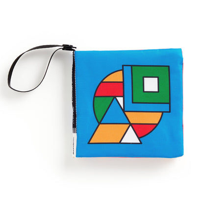Colorful geometric patterned fabric book with a strap on a white background