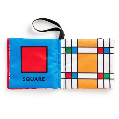 Fabric book pages with geometric designs on a white background