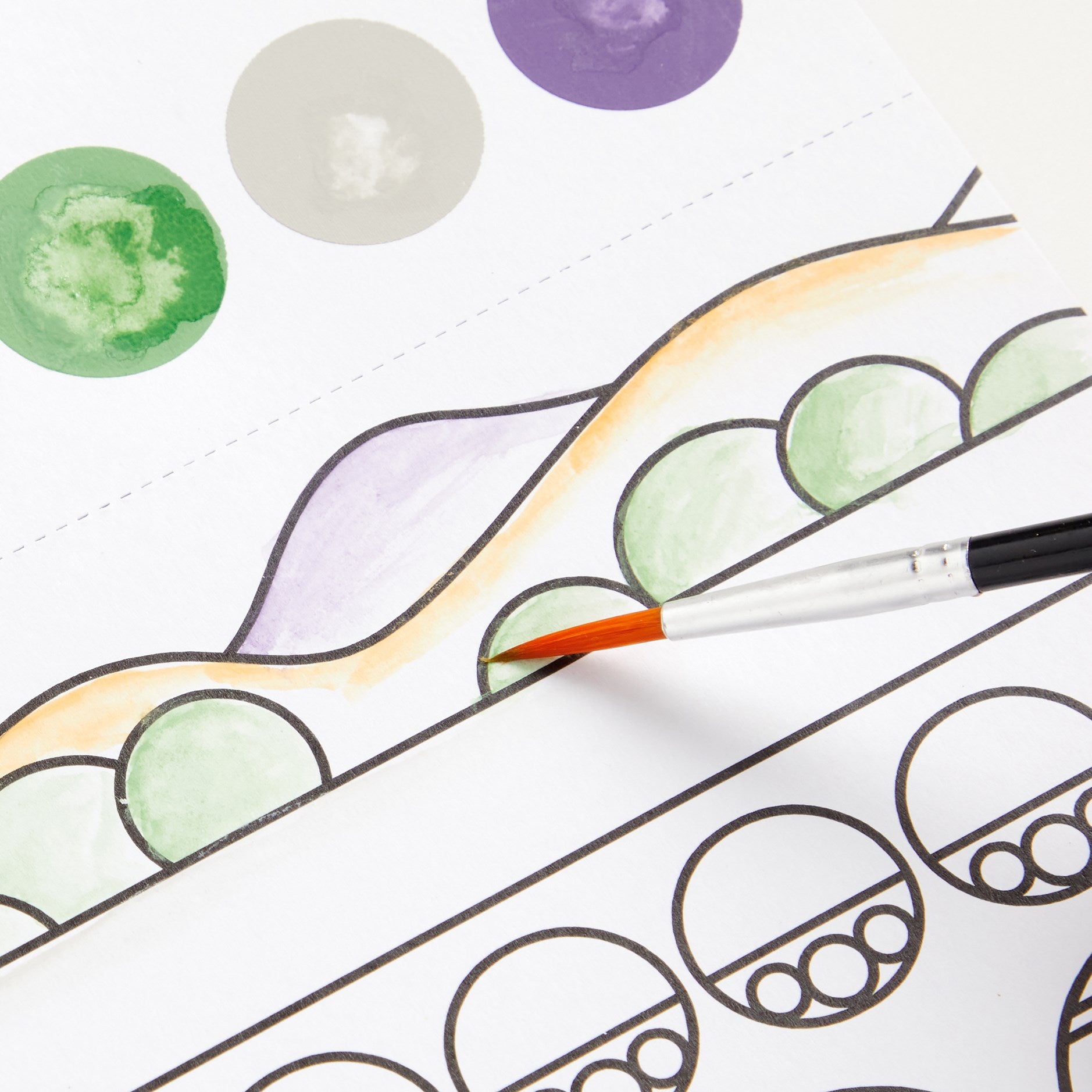 Coloring book page with green and purple circles and a paintbrush.