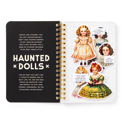Open notebook with 'Haunted Dolls' design on a white background