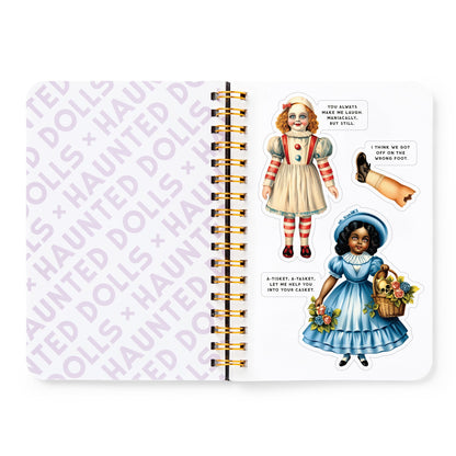 Notebook with vintage-style illustrations of dolls on a white background
