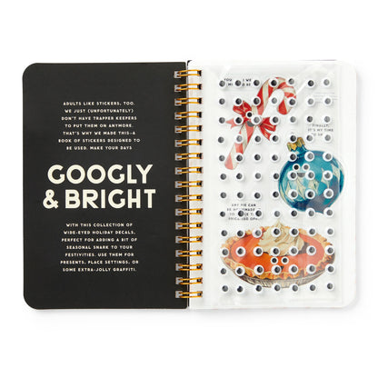 Open notebook with decorative stickers on a white background