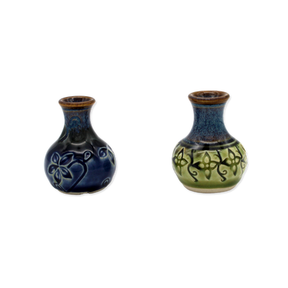 Two ceramic vases with decorative patterns on a white background