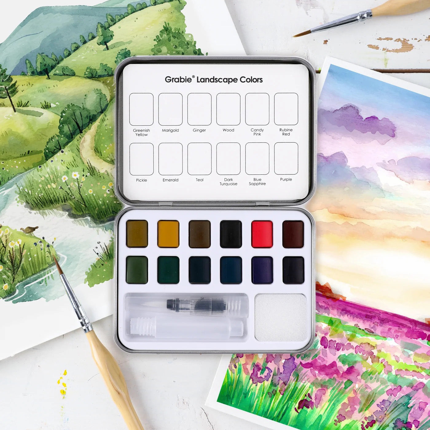 Watercolor paint set with landscape colors on a painting background