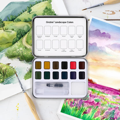 Watercolor paint set with landscape colors on a painting background